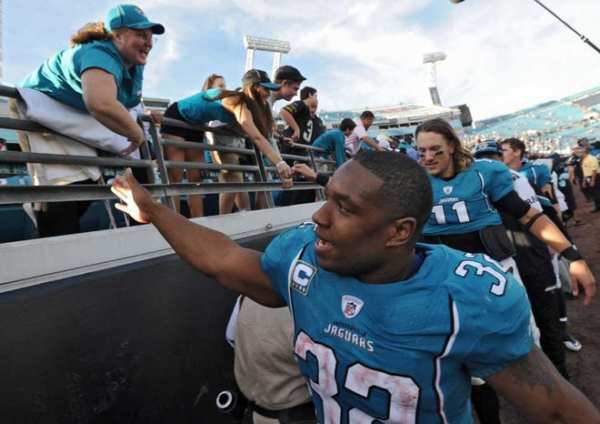 Bob.Mack@jacksonville.com  The Jaguars' Maurice Jones-Drew high-fives fans after a 19-13 win over the Colts on Jan. 1 at EverBank Field.