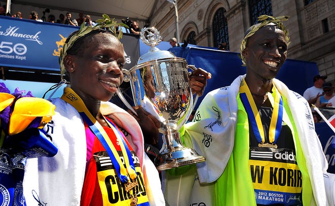 Boston Marathon women's winner Sharon Cherop, left, and men's winner Wesley Korir, both of Kenya, celebrate after their races Monday.
