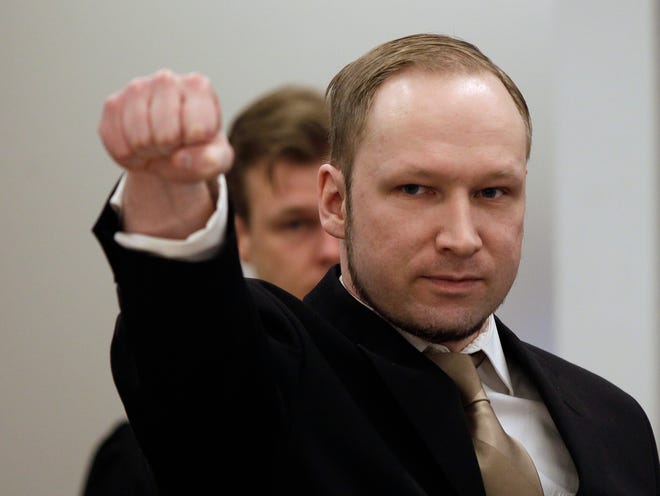 Norwegian Anders Behring Breivik gestures as he arrives at a courtroom, to face terrorism and premeditated murder charges, Oslo, Norway, Monday, April 16, 2012. Breivik, who confessed to killing 77 people in a bomb-and-shooting massacre went on trial in Norway's capital Monday, defiantly rejecting the authority of the court. (AP Photo/Frank Augstein)