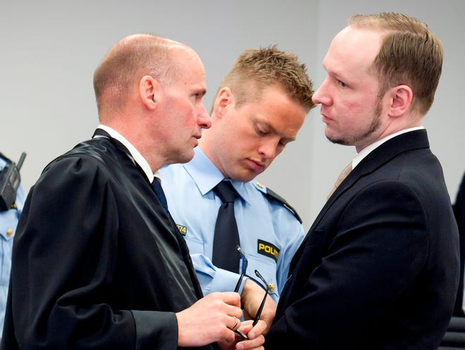 Accused Norwegian Anders Behring Breivik, right, stands with his defense lawyer Geir Lippestad at the courtroom, in Oslo, Norway on Tuesday. Breivik will have five days to explain why he set off a bomb in Oslo's government district, killing eight, and then gunned down 69 at a Labor Party youth camp outside the Norwegian capital. (AP Photo/Heiko Junge/Scanpix Norway/POOL)