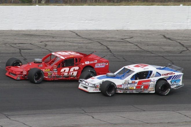 Ted Christopher leads Ronnie Silk on Sunday in the 150-lap Whelen Modified Tour Icebreaker at Thompson Speedway. Silk was awarded the win and Christopher finished second after the apparent winner jumped a restart.