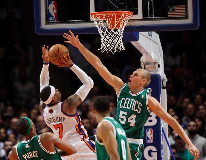 New York Knicks' Carmelo Anthony (7) shoots over Boston Celtics' Greg Stiemsma (54) during the second half of an NBA basketball game Tuesday, April 17, 2012, in New York. The Knicks won the game 118-110. (AP Photo/Frank Franklin II)