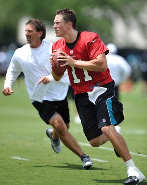 Bruce.Lipsky@jacksonville.com Quarterback Blaine Gabbert (11) is chased by Greg Olson, assistant head coach/quarterbacks coach, during a drill on the first day of the Jacksonville Jaguars' mini-camp Tuesday. Gabbert was also sporting a new haircut.