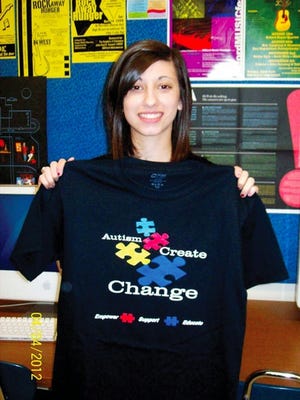 Delaware Valley High School student Talia Rossi holds the T-shirt she designed for Pike Autism Support Services for their Autism Awareness Month Community Campaign. Talia created the original design that incorporated this year's awareness theme 'Create Change.'