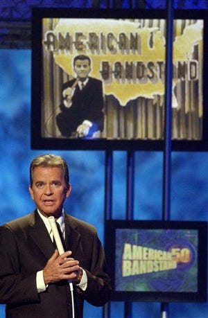 In this April 20, 2002, file photo, Dick Clark, host of the American Bandstand television show, introduces entertainer Michael Jackson on stage during taping of the show's 50th anniversary special in Pasadena, Calif. Clark, the television host who helped bring rock `n' roll into the mainstream on "American Bandstand," died Wednesday, April 18, 2012, of a heart attack. He was 82.