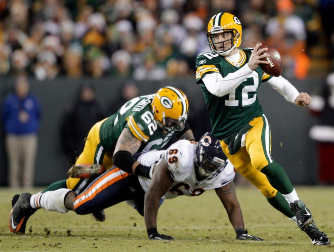 Green Bay Packers quarterback Aaron Rodgers scrambles during the second half of an NFL football game against the Chicago Bears Sunday, Dec. 25, 2011, in Green Bay, Wis.