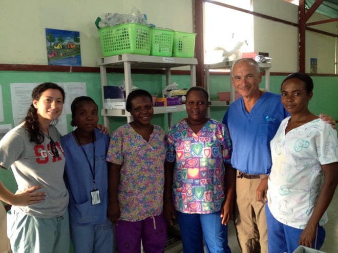 Dr. Anthony Alessi and his daughter, Stephanie, pose with staff members of St. Luc Hospital in Port-au-Prince, Haiti.