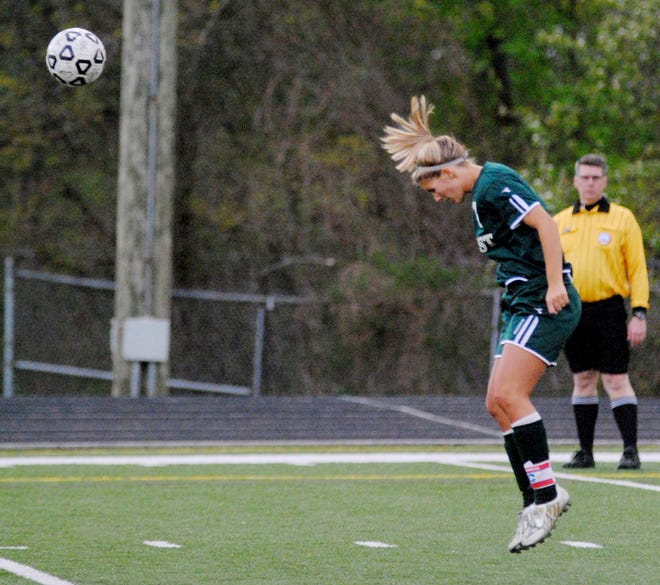 A Zeeland West player heads the ball during the April 18, 2012 game at Holland Christian High School.