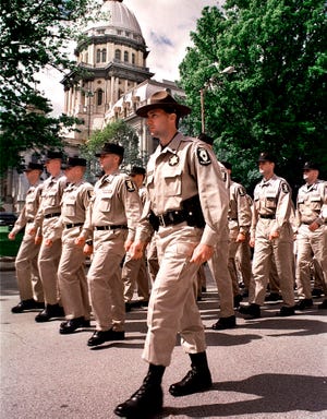 Illinois State Police cadets march in front of the Illinois State Capitol in Springfield, Ill., May 6, 1999. (AP Photo/Seth Perlman, File)
