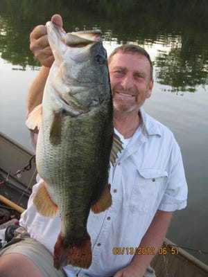CHUCK BORDEN OF LAKELAND released this 10-pound bass at Saddle Creek Park on March 13. Borden, who's boated a number of big bass at Saddle Creek over the years, was casting a black trick worm. Trophy bass season is just about over with. (COURTESY PHOTO)