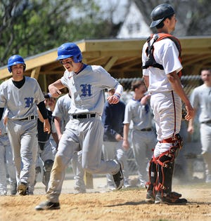 Hopedale's Kevin Lynch scores the game-winning run in the bottom of the seventh as Marlborough catcher Matt Buroni waits for the throw. Pitcher Ian Strom singled Lynch in to give the Blue Raiders a 3-2 win.