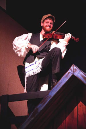 Seth Reedy, a member of the Flagler Youth Orchestra, is the fiddler in "Fiddler on the Roof," on stage through April 29 in Flagler Playhouse.