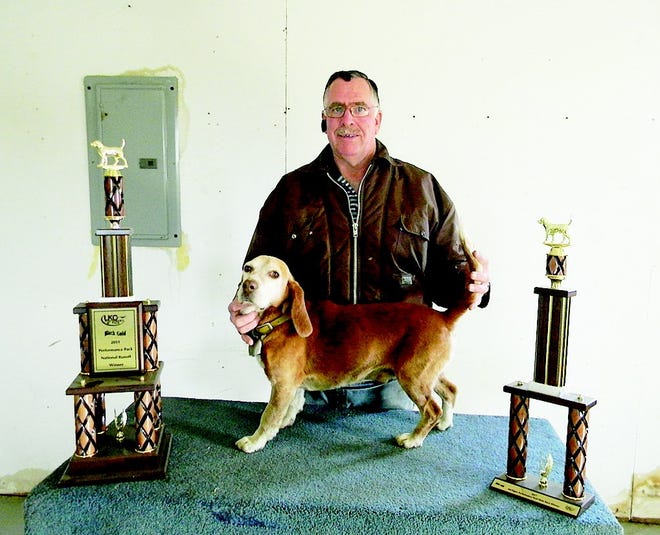 Russell posing with Checker and his recent awards from state and national runoffs.