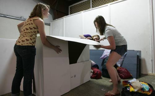 Photo by Amy Herzog/New Jersey Herald - Colleen Minkewicz, left, helps her friends Sarah Anderson, far right, and Molly Hoyer, center, construct their box during “Box City,” an overnight project aimed at raising awareness about homelessness.