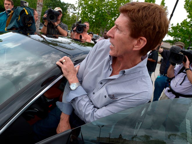 Mark O'Mara, attorney for George Zimmerman, gets into his car after speaking with his client at the Seminole County Jail in Sanford, Fla. on Saturday, April 21, 2012. Zimmerman was a neighborhood watch volunteer who shot unarmed teenager, Trayvon Martin. O'Mara said it would take a few days before Zimmerman is released. His family needs time to secure collateral for the bail, Zimmerman needs to be fitted with an electronic monitoring device and O'Mara said he must find a secure location for him. (AP Photo/Phelan M. Ebenhack)