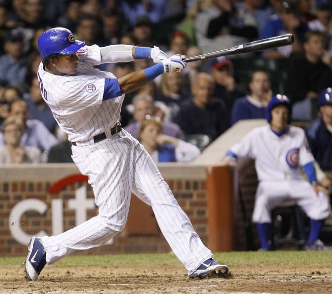 Chicago Cubs' Starlin Castro swings through a home run off Milwaukee Brewers starting pitcher Shaun Marcum during the sixth inning of a baseball game Tuesday, Sept. 20, 2011, in Chicago.