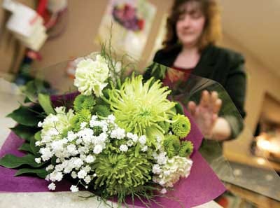 Photos by Daniel Freel/New Jersey Herald Above, shop owner Raeann Martin, prepares a bouquet at Blooms of Elegance Flowers and Gifts.