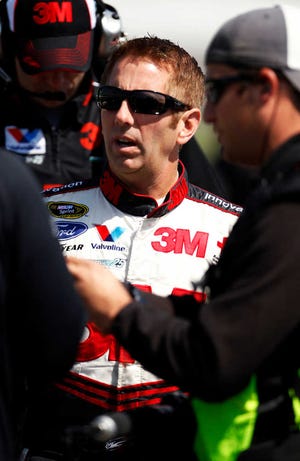 Greg Biffle waits on pit row during qualifying for the NASCAR Sprint Cup Series auto race at Kansas Speedway in Kansas City, Kan., Saturday, April 21, 2012. (AP Photo/Orlin Wagner)
