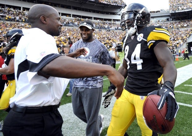 Steelers running backs coach Kirby Wilson and Rashard Mendenhall  celebrate after Mendenhall scores on a fifty yard touchdown run in overtime against Atlanta in 2010.