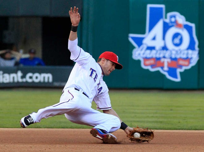 Texas Rangers third baseman Michael Young catches a grounder hit by the New York Yankees' Andruw Jones Monday in Arlington. Young made the throw to first for the out.