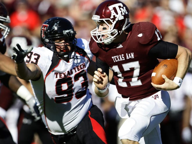 In this Oct. 30, 2010 file photo,Texas A&M quarterback Ryan Tannehill looks for running room on a busted play against the Texas Tech defense in the second quarter of an NCAA football game at Kyle Field in College Station, Texas. Tannehill had a school-record 449 yards passing and four touchdowns in his first career start.