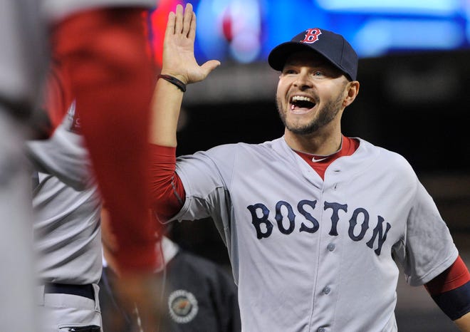 Boston's Cody Ross, who hit two home runs, celebrates after the Red Sox beat the Minnesota Twins 6-5 in a baseball game Monday, April 23, 2012, in Minneapolis.