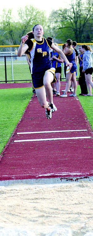G-A’s Molly Nowell flies during her triple jump. the sophomore won the triple jump and the 200 in Tuesday’s meet.
