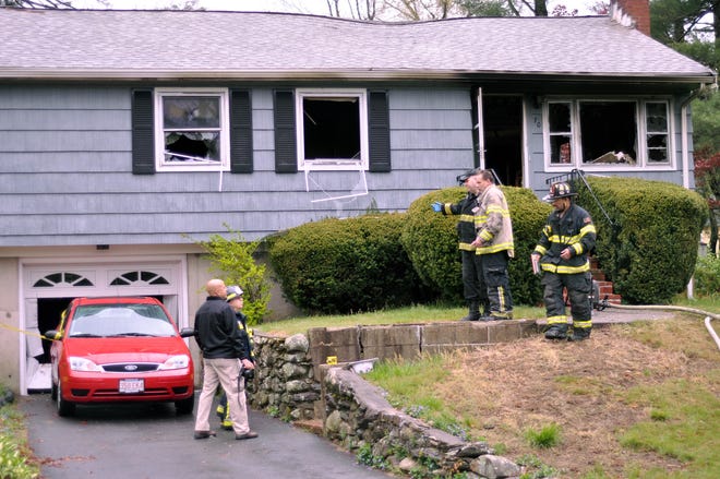 Deputy Bridgewater Fire Chief Tom Levy, right center, works with investigators at the fatal fire at 70 Winter St. in Bridgewater on Monday, April 23, 2012.