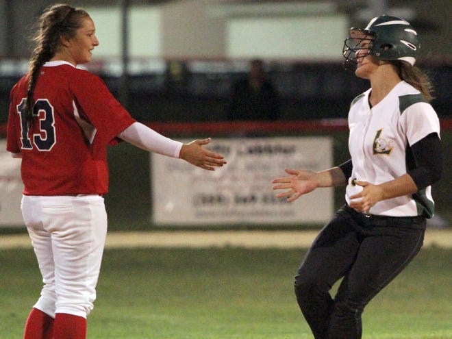 Vanguard shortstop Ashley Spell, left, congratulates Lecanto's Amber Atkinson on her second home run, Tuesday night's game-winner at VHS.