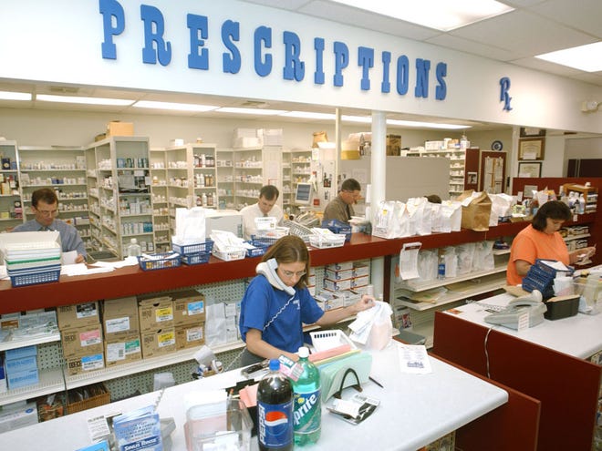 Employees fill prescriptions at Jim Myers Drug in 2004. The pharmacy chain is being sold to Walgreen Co., which has agreed to keep Jim Myers services, like home delivery.