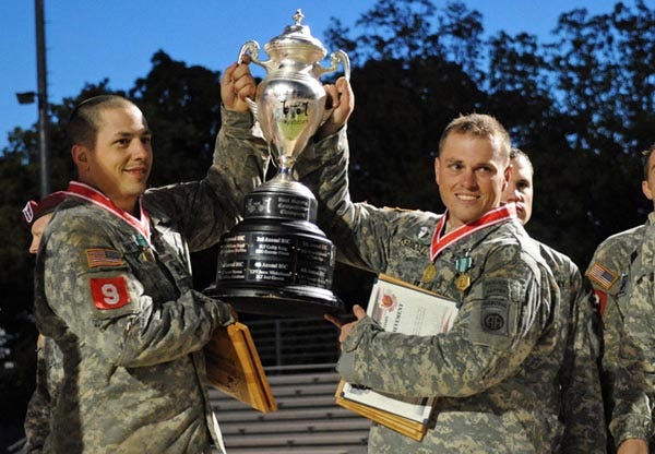 Staff Sgt. Frank Batts, left, and Capt. Mike Kendall hold up the trophy they won at the 2012 Best Sapper Competition which ran for 53 straight hours at Fort Leonard Wood, Mo., April 19 to 21. Both Soldiers are assigned to the 82nd Airborne Division’s 3rd Brigade Combat Team.