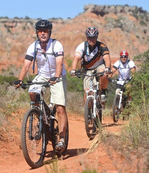Roberto Rodriguez / Amarillo Globe-News President George W. Bush leads a pack of riders on a trial during the second day of The Bush Center Warrior 100k, Friday, April 12, 2012 at Palo Duro Canyon State Park.