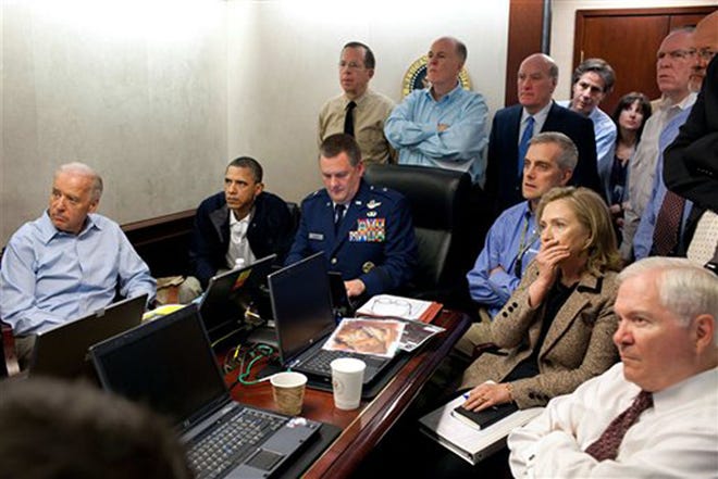FILE - In this May 1, 2011, image released by the White House and digitally altered by the source to obscure the details of a document in front of Secretary of State Hillary Rodham Clinton, at right with hand covering mouth, President Barack Obama, second from left, Vice President Joe Biden, left, Secretary of Defense Robert Gates, right, and members of the national security team watch an update on the mission against Osama bin Laden in the Situation Room of the White House in Washington. When Obama first spoke of bin Laden's demise, he asked the nation to think back to the unity of Sept. 11. Now the killing of America's most wanted is something else: a concentrated campaign weapon against Mitt Romney, even a bumper sticker message. (AP Photo/The White House, Pete Souza)