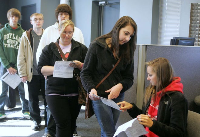 Mia Cece (second from right) and Anna Veruchi (right) chat as they wait to be interviewed during a job fair for summer positions with the Rockford RiverHawks on Saturday, April 21, 2012, in Loves Park.