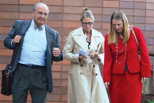 In this April 18, 2012 photo, Rita Crundwell, center, the comptroller in Dixon, leaves federal court in Rockford with attorneys Paul Gaziano, left, and Kriston Carpenter after being freed on a recognizance bond. Crundwell was arrested April 17 and accused of stealing $30 million from the city of Dixon to fund a lavish lifestyle and run one of the nation's leading horse breeding operations.