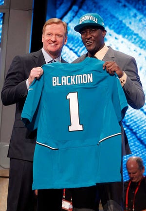 Oklahoma State wide receiver Justin Blackmon, right, poses with NFL Commissioner Roger Goodell after being selected with the fifth pick in the NFL Draft by the Jacksonville Jaguars.
