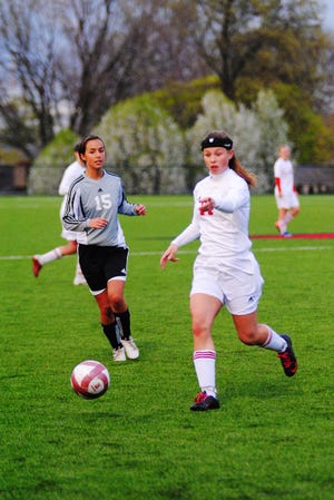 Holland High's Rachael Starr prepares to kick the ball during their home game against West Ottawa on March 28, 2012.