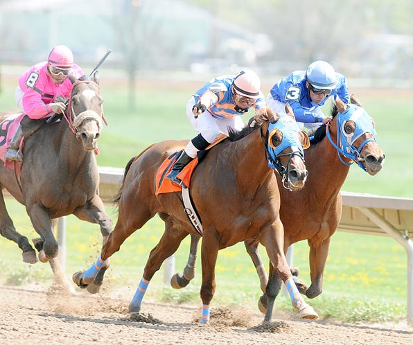 John Davila, Jr. aboard Howie and the Cat leads eventual third place finisher Luis Perez (3) aboard Tax Return in the first race of the Season Opener at Finger Lakes Casino & Race Track.