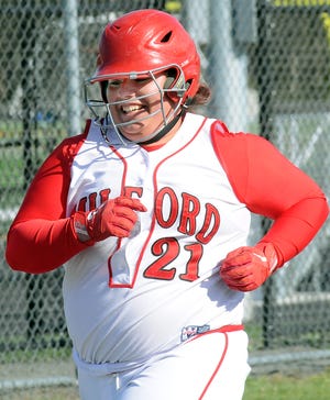 Milford's Caroline Fairbanks smiles after her first-inning home run yesterday.