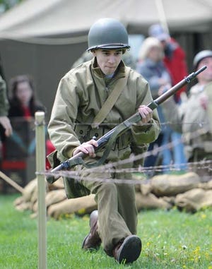 Photo by Amy Herzog/New Jersey Herald - Mike Attanasir, of the 94th Living History and Re-enacting Unit, demonstrates military strategy from World War II during the 11th annual Military Vehicle Show and Swap Meet at the Sussex County Fairgrounds.