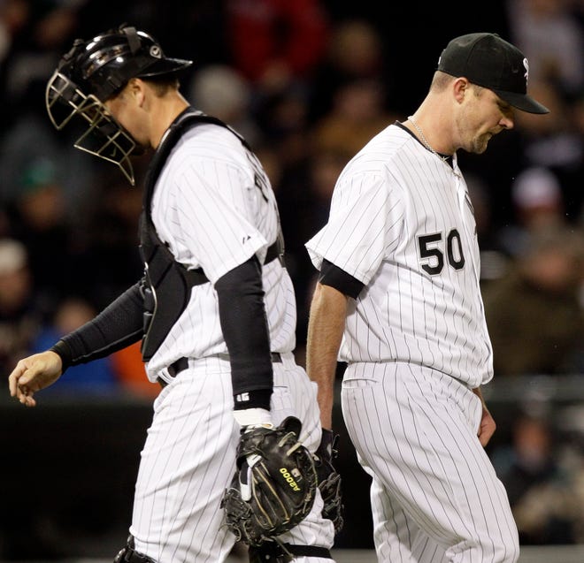 Chicago White Sox starter John Danks, right, and catcher A.J. Pierzynski look down during the sixth inning of a baseball game against the Boston Red Sox in Chicago, Friday, April 27, 2012.