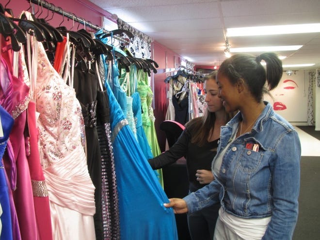 Peg Quann 
 Sales consultant Allison Balchiunas (left) shows prom dresses to Joy Johnson of Mount Laurel at Rene Elle Couture shop in Maple Shade.