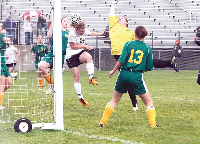 Belding’s Kenzi Krieger heads the ball into the net off of the corner kick from teammate Charlene Kehoe Monday night in the Redskins game against Comstock Park.