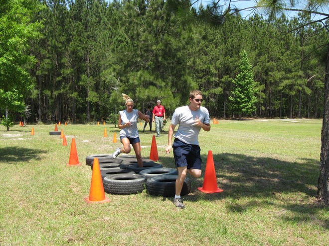 Dash Coleman/Savannah Morning NewsBradley Hill, 22, of Garden City and Heather Gergerich, 30, of Ludowici run the Peace Officer Academy obstacle course at Savannah Technical College's Crossroads campus on Monday.