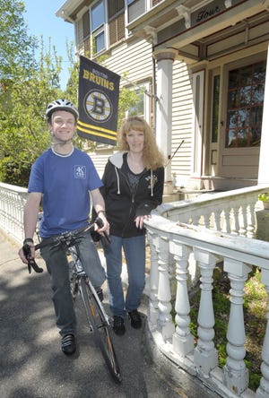 Cyclist Zachary Boyer is joined by his mother, Kerstin Mingels, outside their Freetown home.