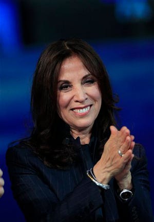 In this April 14, 2012 file photo, Olivia Harrison, the widow of George Harrison, former member of The Beatles attends the Italian State RAI TV program "Che Tempo che Fa", in Milan, Italy. George Harrison's widow Olivia hopes to add a more personal side to the reticent Beatle with her new multi-touch book. Based on the documentary, “George Harrison: Living in the Material World,” the book is available Tuesday, May 1, on the iTunes bookstore. It includes audio, video material from the film along with personal photographs, letters, and memorabilia never seen by the public. (AP Photo/Luca Bruno, file)