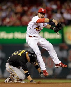 The Pittsburgh Pirates' Clint Barmes, left, is out at second as St. Louis Cardinals second baseman Skip Schumaker turns the double play during the fifth inning of Tuesday's game in St. Louis.