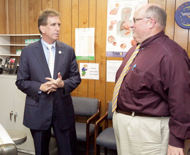 INDEPENDENT RAY STEWART
Congressman Jim Renacci visits with Western Stark Free Clinic Executive Director Gary Feagles.