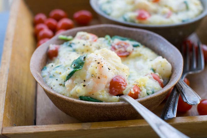 In this image taken March 19, 2012, cookbook author Nathalie Dupree's Shrimp and Grits with spinach and tomatoes recipe is shown in Concord, N.H. (AP Photo/Matthew Mead)
