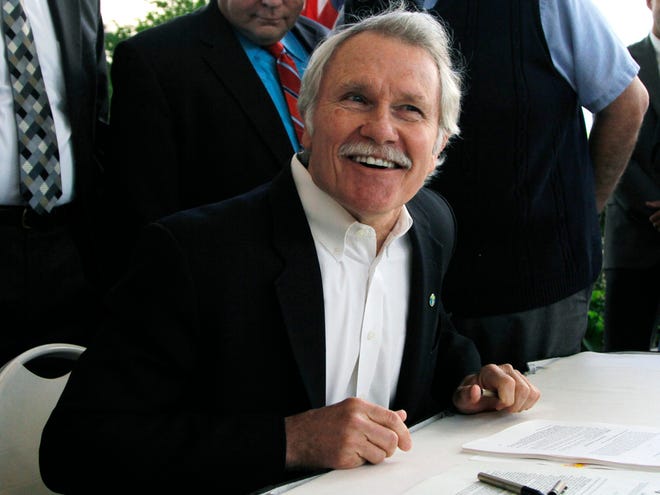 In this July 1, 2011 file photo, Oregon Gov. John Kitzhaber smiles after signing two health care bills in Portland, Ore. The Obama administration is buying into Oregon's ambitious health care initiative, announcing Thursday that it's tentatively agreed to chip in $1.9 billion over five years to help get the program off the ground. The federal government could save $1.5 trillion over the next 10 years if all 50 states adopted Oregon's approach, the governor said. (AP Photo/Don Ryan, file)
